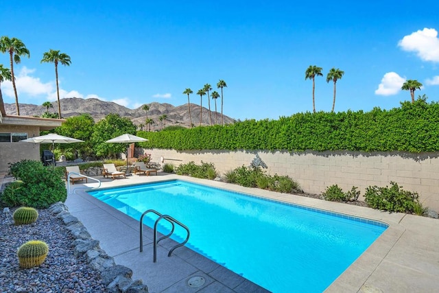 view of pool featuring a mountain view and a patio