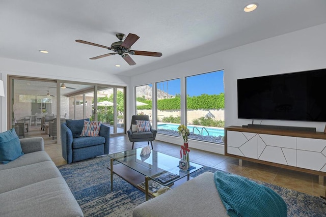 living room featuring ceiling fan and tile patterned floors