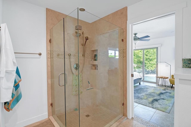 bathroom featuring a shower with shower door and ceiling fan