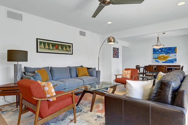 living room with ceiling fan and light wood-type flooring