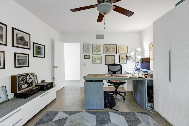 office area with light tile patterned floors and ceiling fan