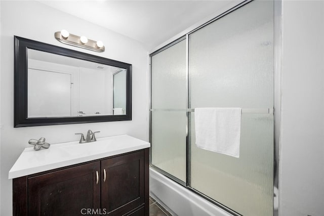 bathroom featuring shower / bath combination with glass door, vanity, and tile patterned flooring