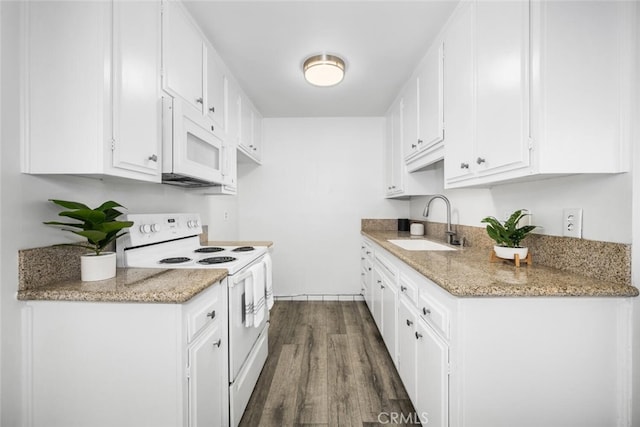 kitchen with sink, white appliances, white cabinets, dark hardwood / wood-style flooring, and light stone counters