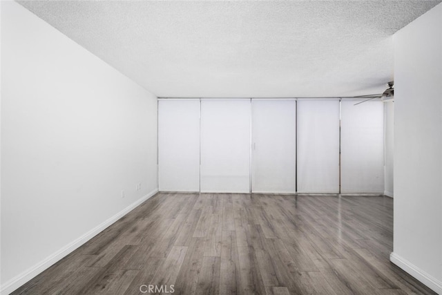 unfurnished bedroom with hardwood / wood-style flooring, a textured ceiling, and a closet