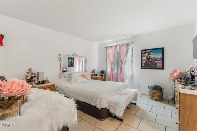 bedroom with light tile patterned floors