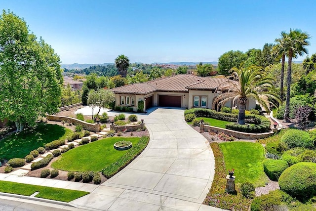 mediterranean / spanish-style house with a front lawn and a garage