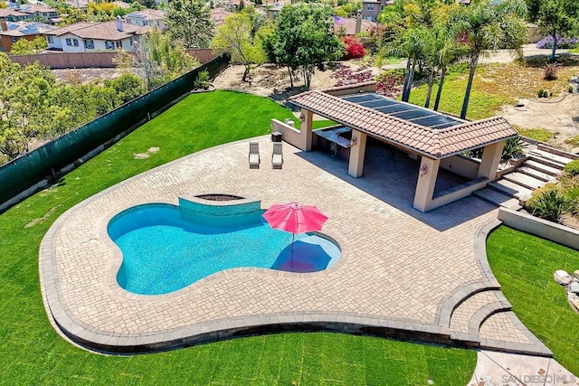 view of swimming pool featuring a patio area and a yard