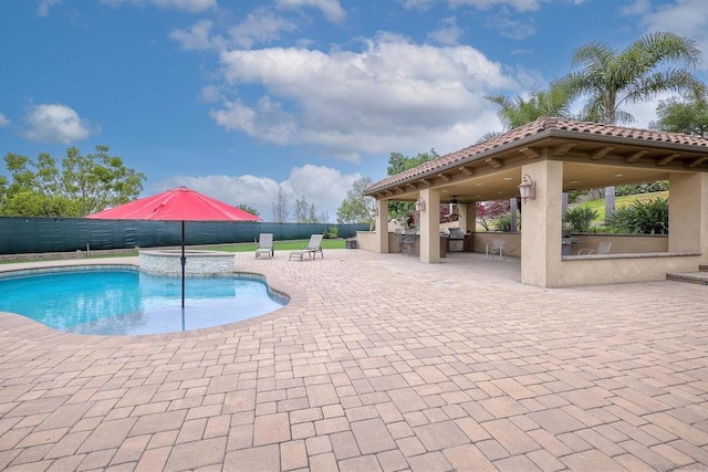 view of swimming pool featuring a gazebo, an outdoor bar, a patio area, and area for grilling