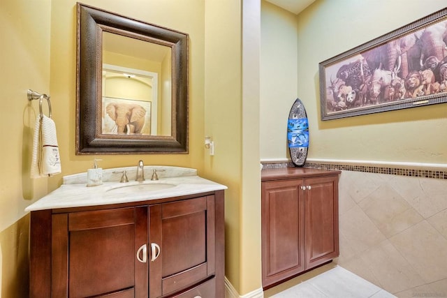 bathroom with tile walls, tile patterned floors, and vanity