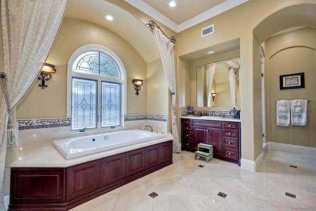 bathroom with vanity, tile patterned flooring, ornamental molding, and a bathtub