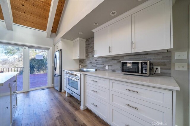 kitchen with wooden ceiling, stainless steel appliances, backsplash, and lofted ceiling with beams