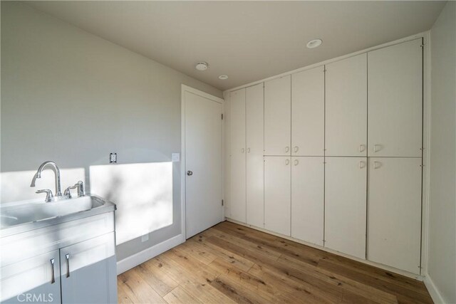 interior space featuring light wood-type flooring and sink