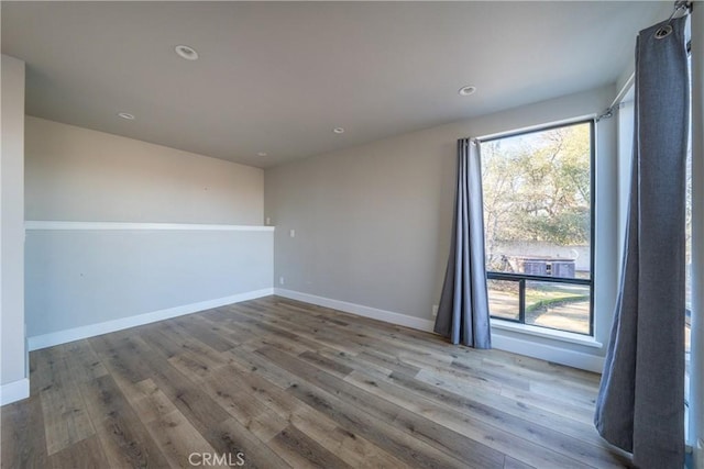 spare room with hardwood / wood-style floors