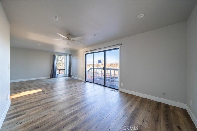 spare room featuring ceiling fan and light hardwood / wood-style floors