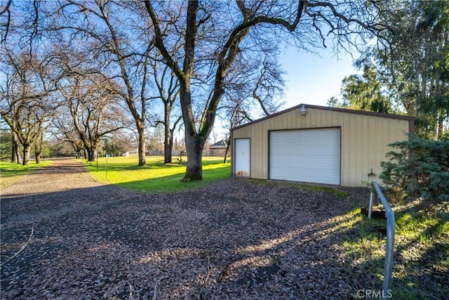 detached garage featuring driveway