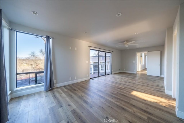 unfurnished room featuring a ceiling fan, recessed lighting, light wood-style flooring, and baseboards