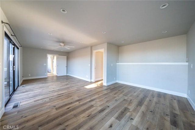 unfurnished living room with ceiling fan and hardwood / wood-style floors