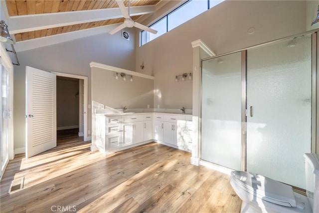 bathroom featuring beam ceiling, ceiling fan, a shower stall, wood finished floors, and wooden ceiling