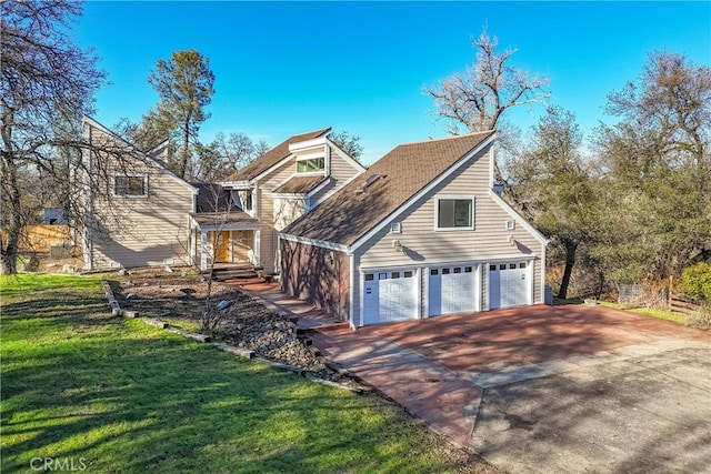 view of front of house with a front yard and a garage