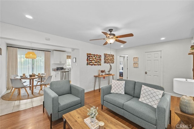 living room with ceiling fan and wood-type flooring