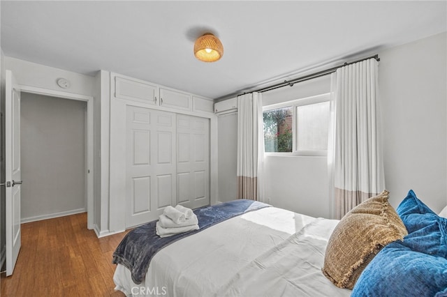 bedroom with a closet and hardwood / wood-style floors