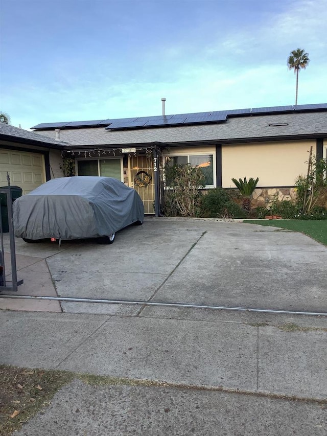 ranch-style home with solar panels