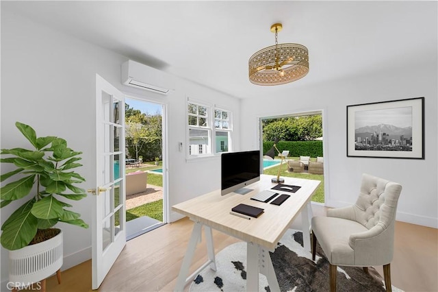 office space with light wood-type flooring and a wall mounted AC