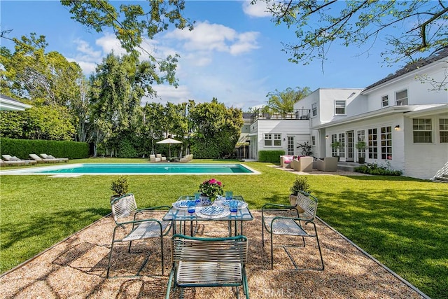 view of pool with a lawn, an outdoor hangout area, and a patio