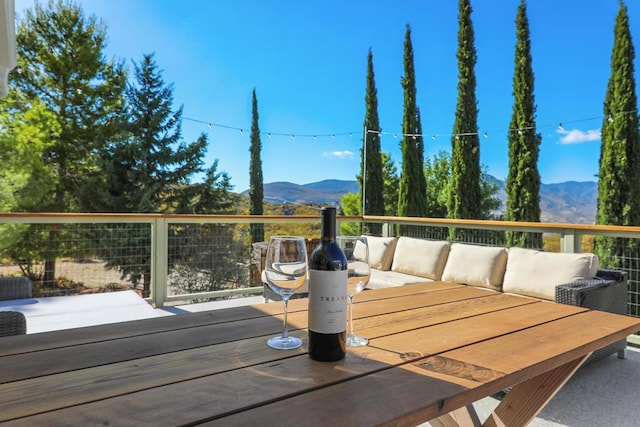 wooden terrace with outdoor lounge area and a mountain view