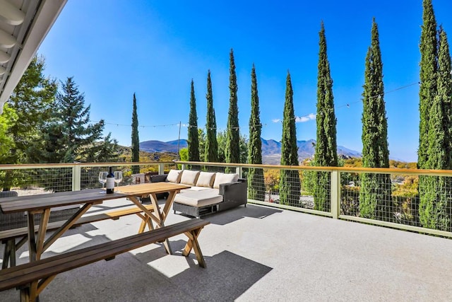 view of patio featuring a mountain view and an outdoor living space