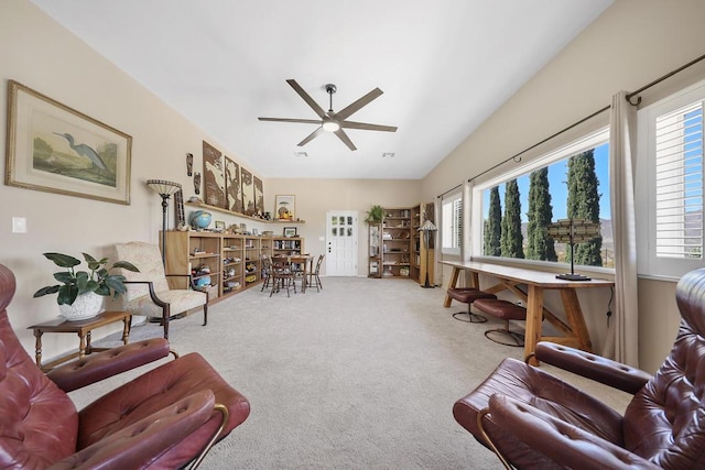 carpeted living room with ceiling fan