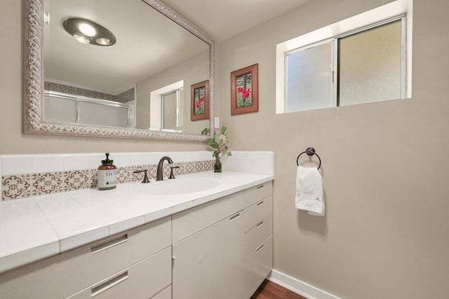 bathroom featuring vanity, an enclosed shower, and wood-type flooring