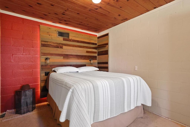 bedroom with wood walls and wooden ceiling