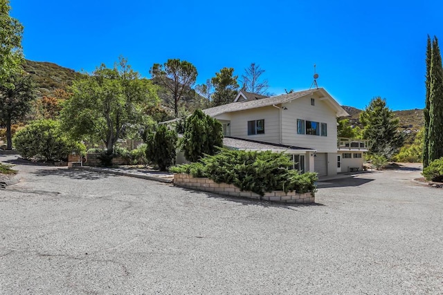 view of side of home with a mountain view