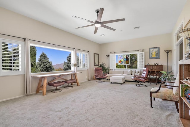 living room with light colored carpet and ceiling fan