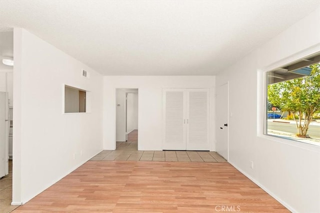 spare room with light wood-type flooring