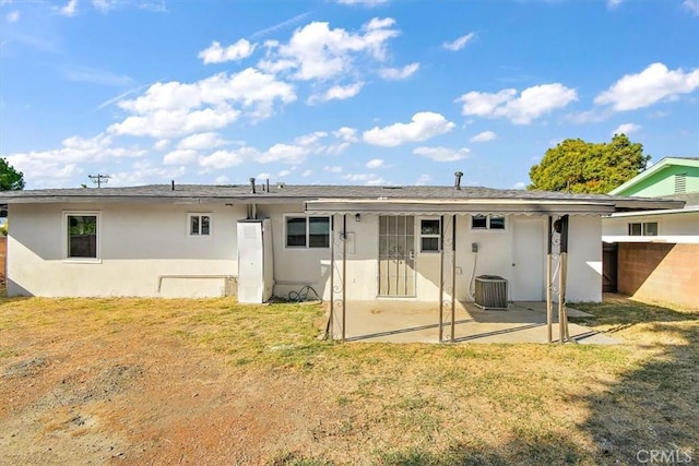 back of house with a patio area, cooling unit, and a lawn