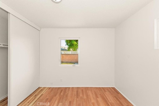 empty room with light hardwood / wood-style floors