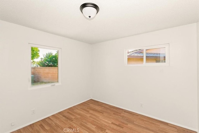 unfurnished room with hardwood / wood-style floors