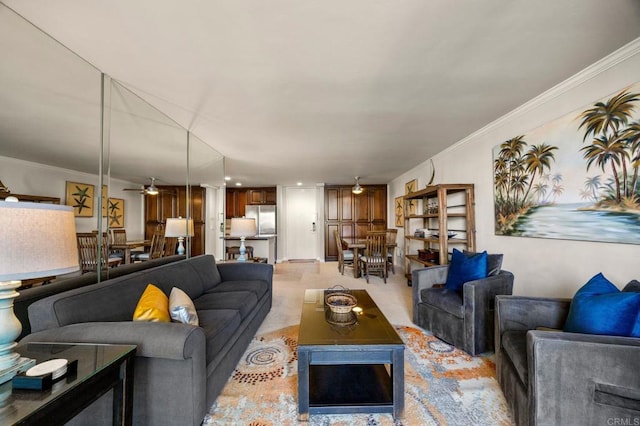 living room with ceiling fan and ornamental molding