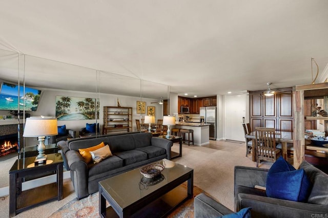 carpeted living room featuring ceiling fan