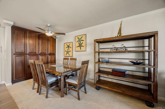 dining room featuring ceiling fan, ornamental molding, and light hardwood / wood-style flooring