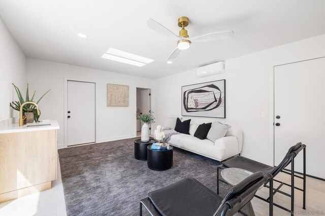 living room featuring ceiling fan and an AC wall unit