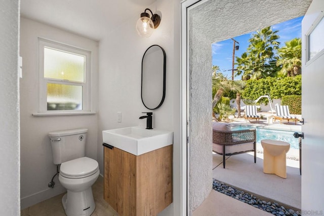 bathroom with toilet and vanity