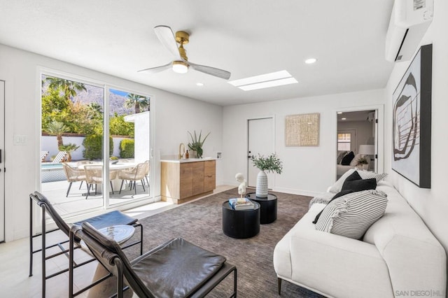 living room with ceiling fan and a wall mounted AC