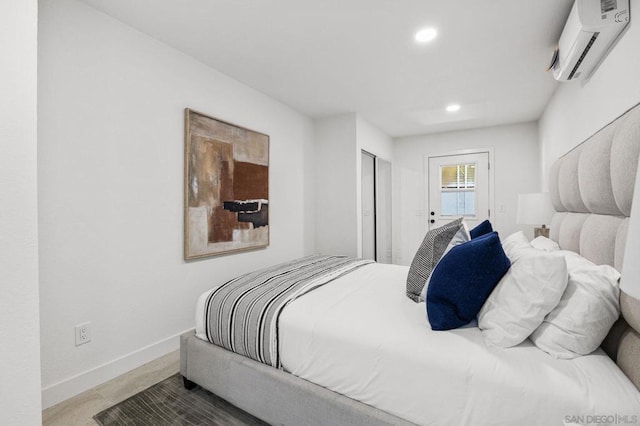 bedroom featuring a closet, hardwood / wood-style flooring, and a wall unit AC