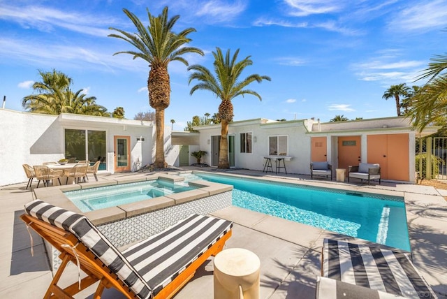 view of pool with an in ground hot tub and a patio area