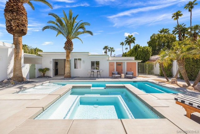 view of pool featuring an in ground hot tub and a patio