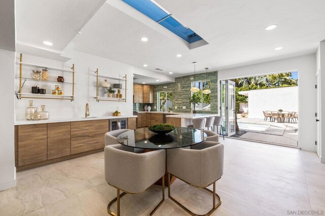 dining space with wine cooler and sink