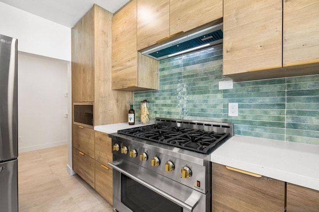 kitchen featuring ventilation hood, decorative backsplash, and appliances with stainless steel finishes